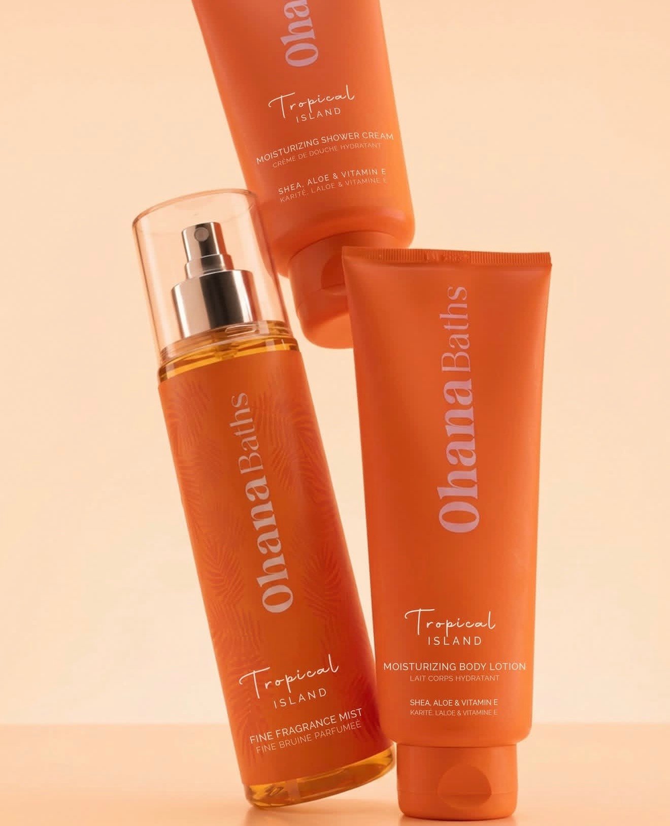 Hands squeezing fresh mango over Ohana Baths tropical shower cream